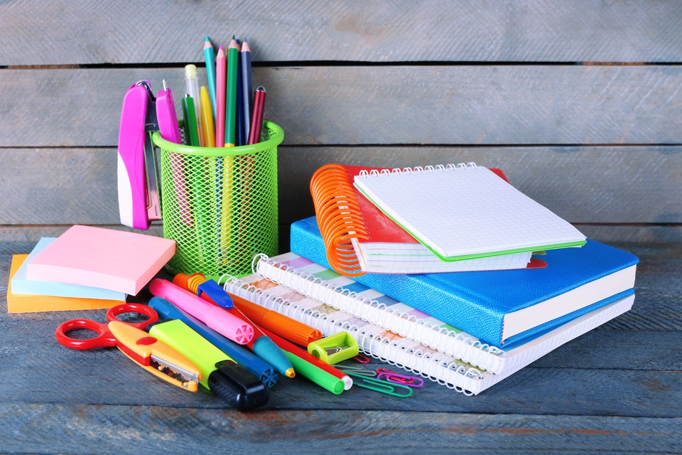 Colorful stationery on wooden background